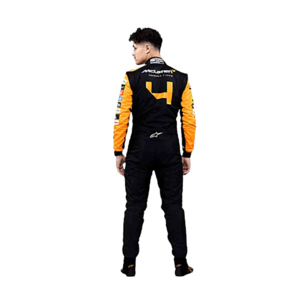 Person wearing a black and orange racing suit with visible branding on a white background