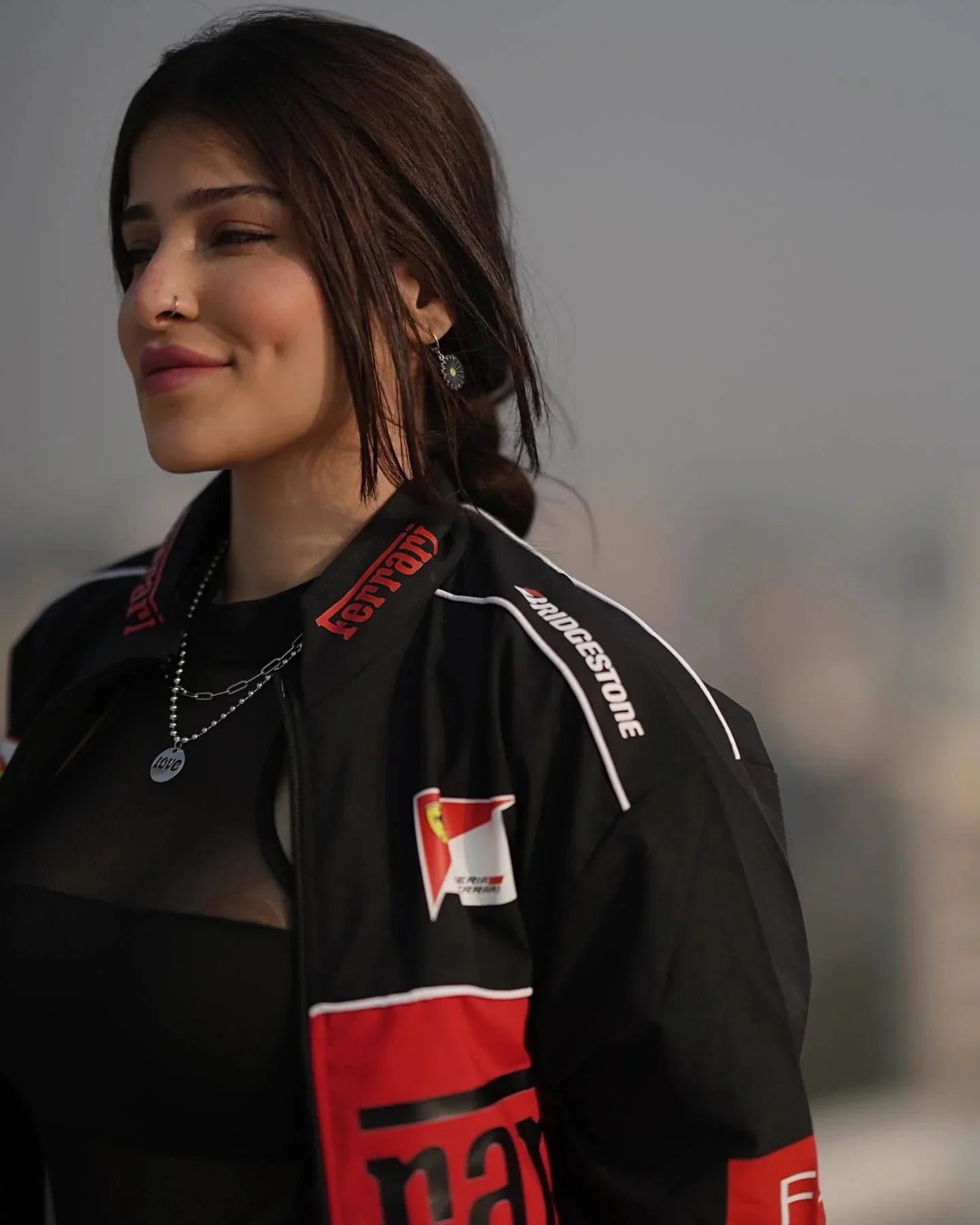 Woman wearing a black and red jacket with visible branding