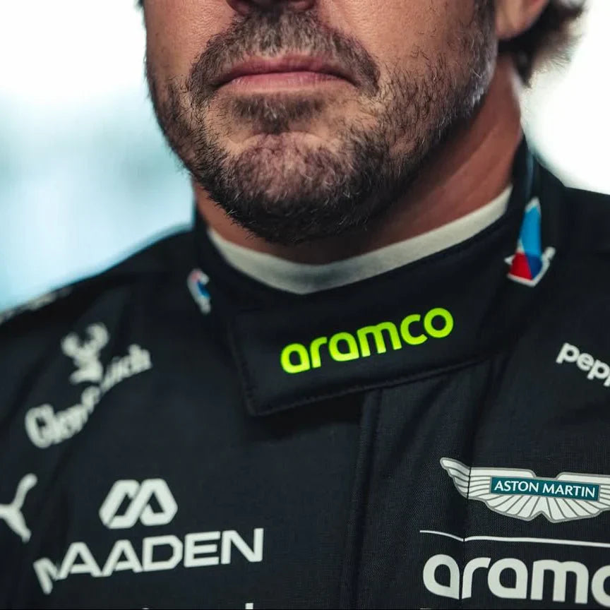 Close-up of a person wearing a racing suit with various sponsor logos.