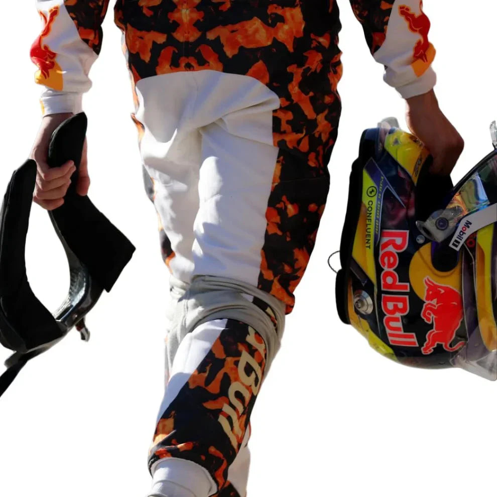 Person wearing colorful racing suit with Red Bull branding, holding a helmet.