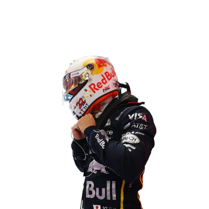Person wearing a Formula 1 racing helmet and suit with visible branding on a white background