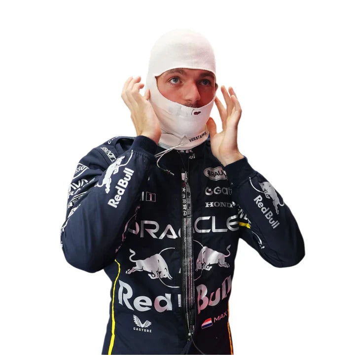 Person wearing a racing suit with multiple brand logos on a white background